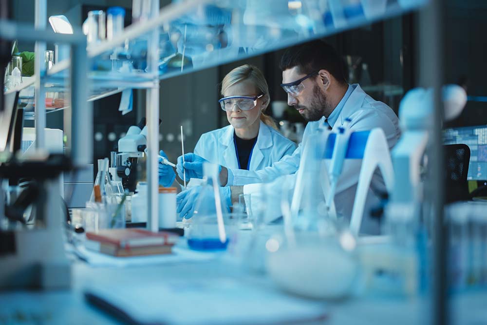 Two scientists are working in lab.